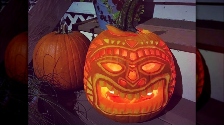 A pumpkin carved to look like a tiki god