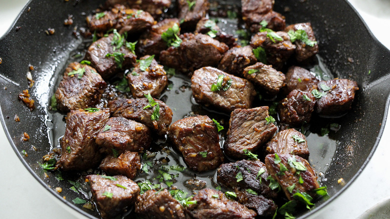 steak pieces in frying pan