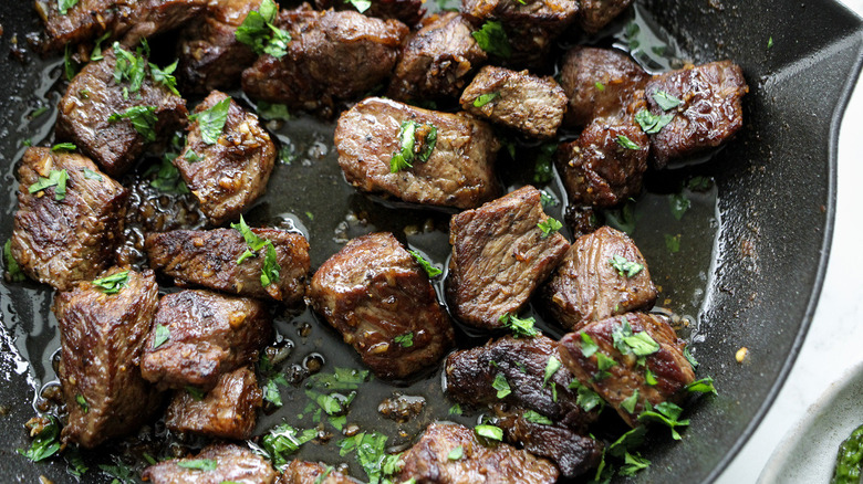 steak pieces in frying pan