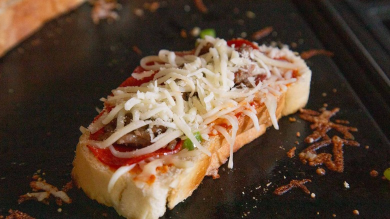 pizza toppings on top of bread