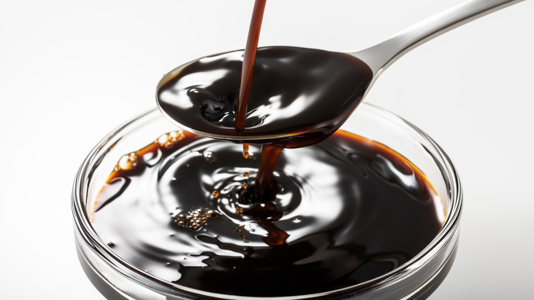 Worcestershire sauce pouring into spoon