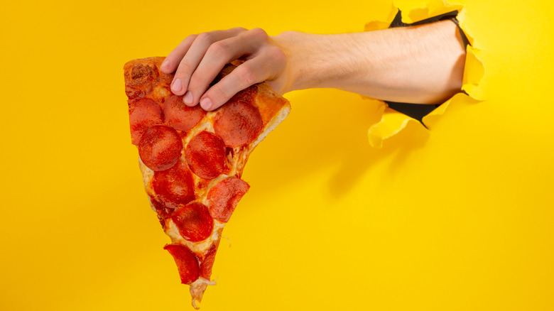 Holding pizza slice through hole