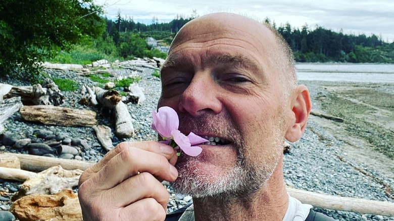 Les Stroud eating a flower