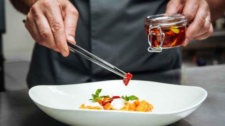 A chef plating a dish