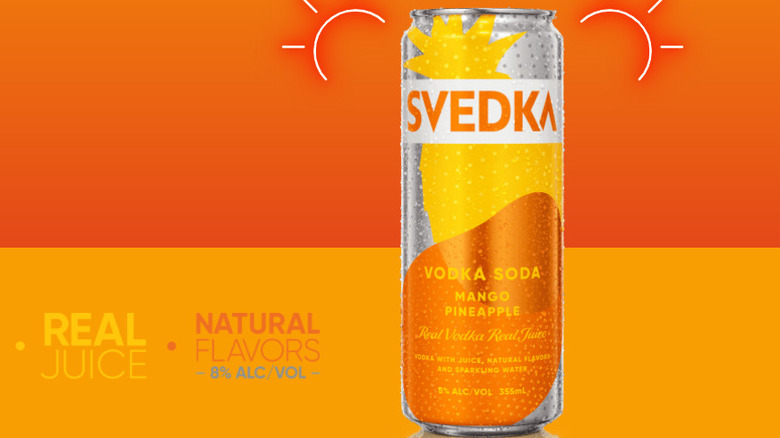 Vodka soda mango pineapple on orange background