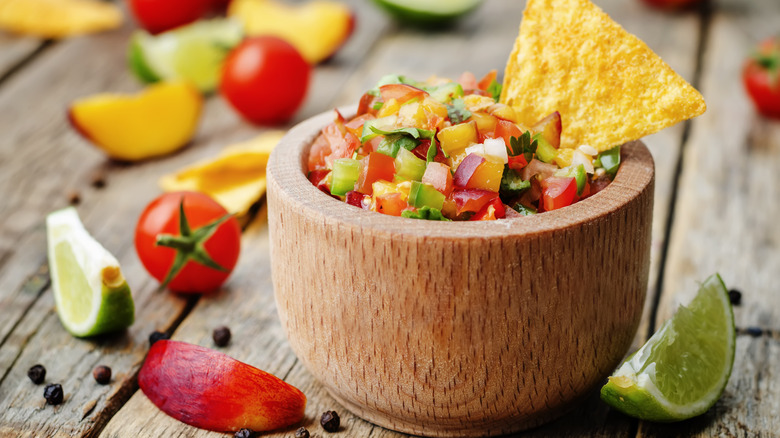 Peach salsa in a brown bowl