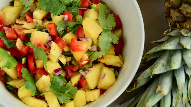 White bowl of pineapple salsa