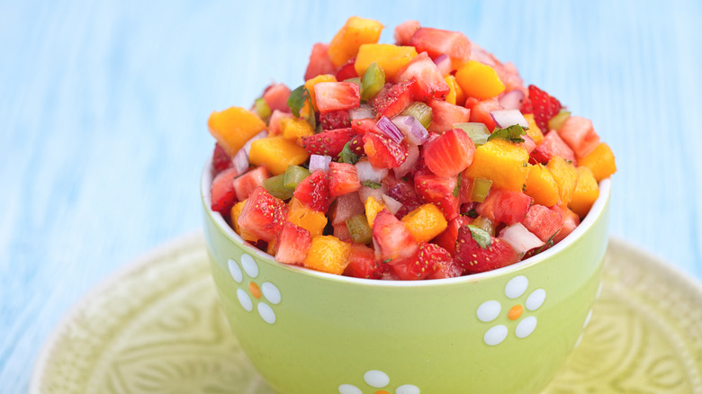 Green cup of strawberry mango salsa