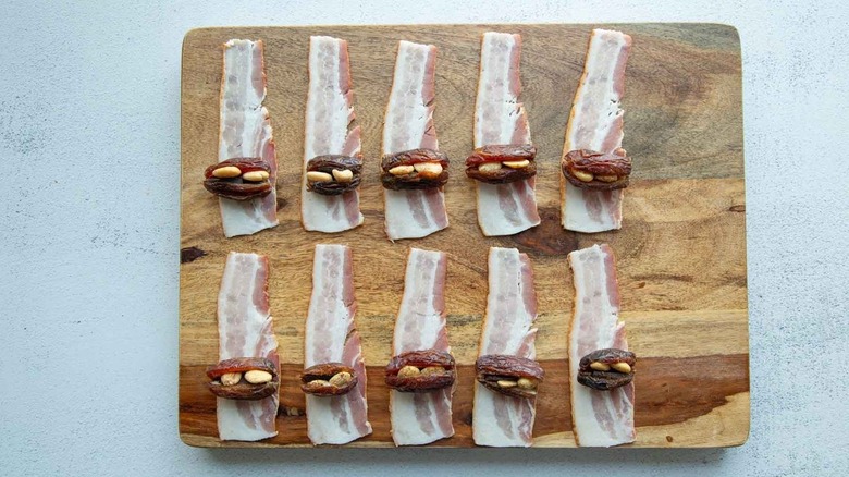 dates sitting on raw bacon