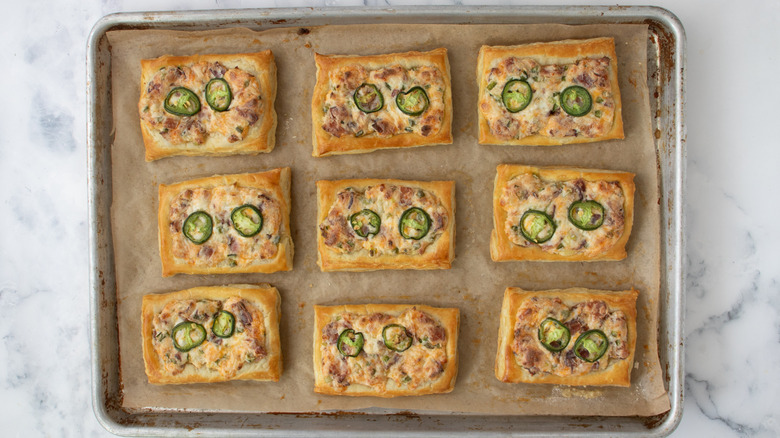 baked cheese and jalapeño tarts on baking sheet