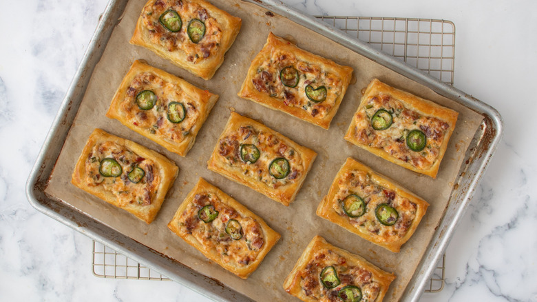 baked cheese and jalapeño tarts on rack