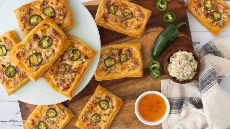 baked cheese and jalapeño tarts on wooden board