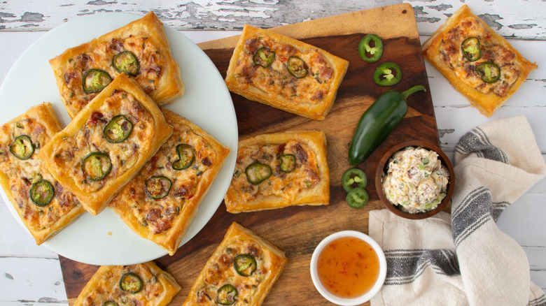 baked cheese and jalapeño tarts on wooden board