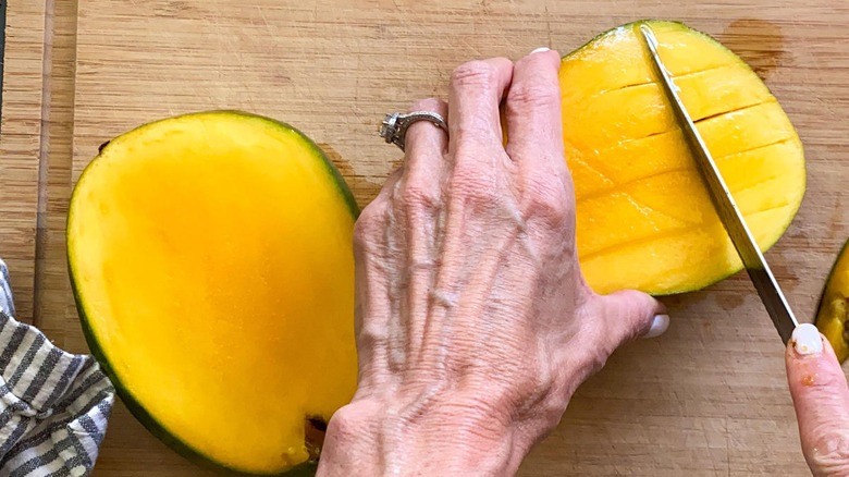 scoring mango meat with knife