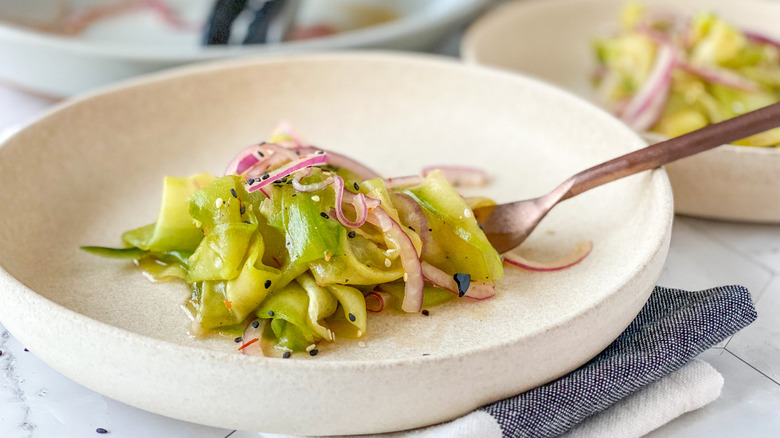 Cucumber onion salad on fork