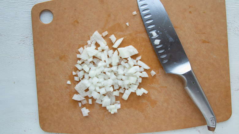 chopped onions on cutting board