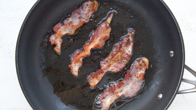 bacon frying in pan