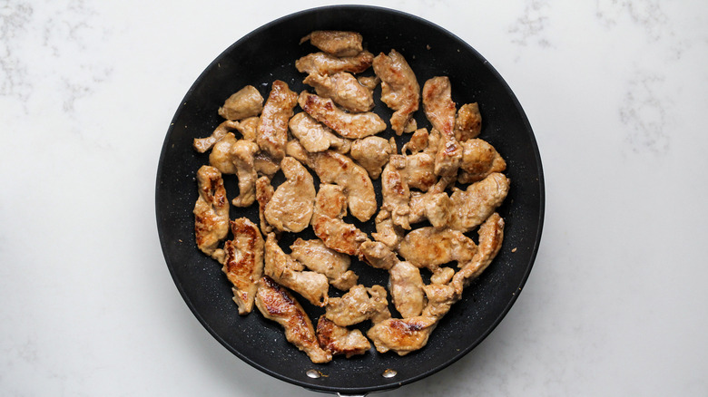 browned pork pieces in skillet