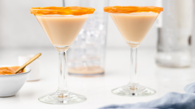 Two crème brûlée martinis in caramel-rimmed glasses