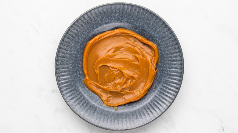 Layer of caramel sauce spread onto plate