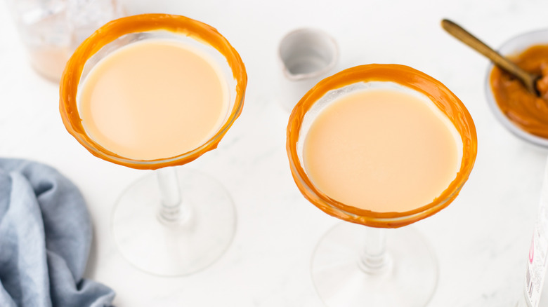 Two crème brûlée martinis in caramel-rimmed glasses