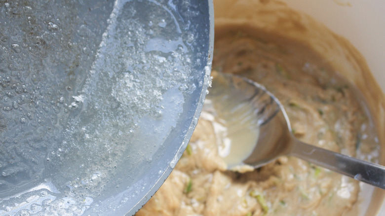 sugar being poured into tahini