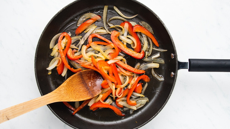 Onion and pepper frying in pan