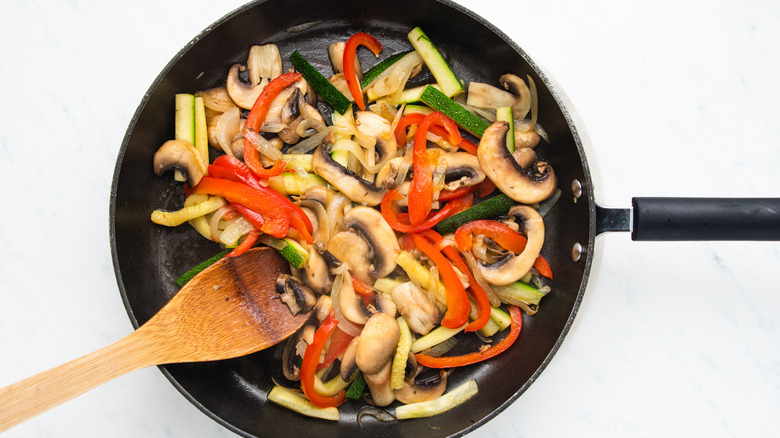 Vegetables frying in pan