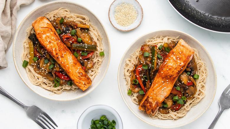 Two bowls of salmon stir-fry