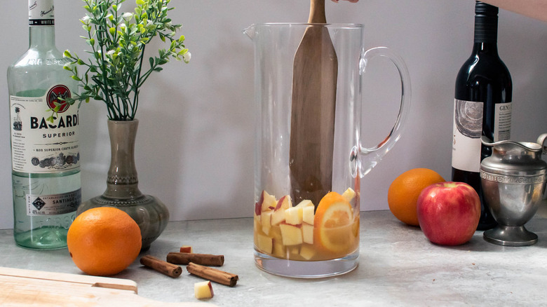 muddling fruit in pitcher