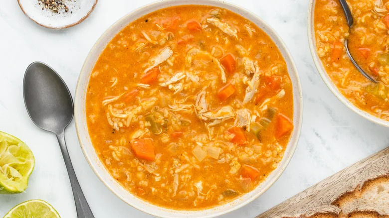 Chicken soup with carrots in bowls