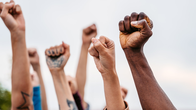 people protesting arms in the air