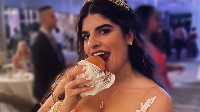 Woman eating McDonald's at wedding