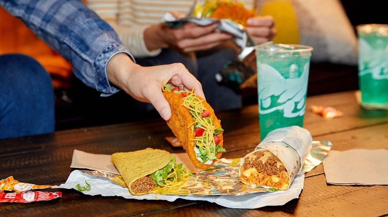 Close-up of hand holding Naked Chicken Chalupa 