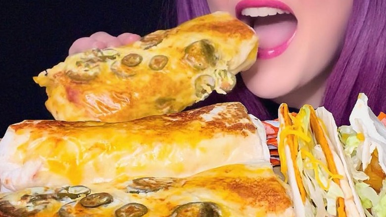 girl eating spicy grilled cheese burrito