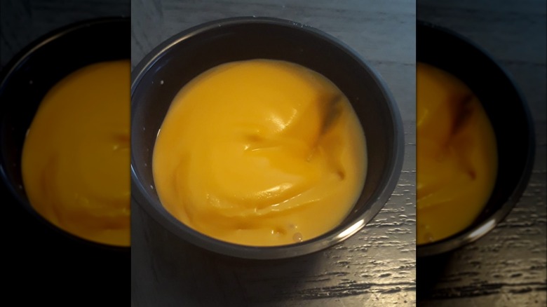 Taco Bell Nacho Cheese in small black container