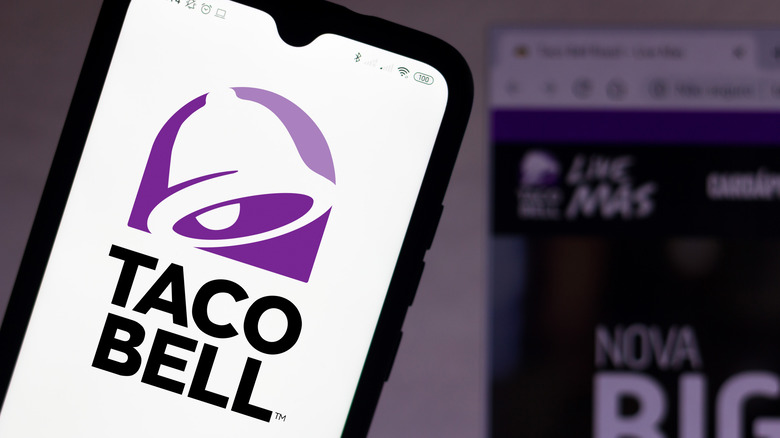 A phone displaying the Taco Bell logo