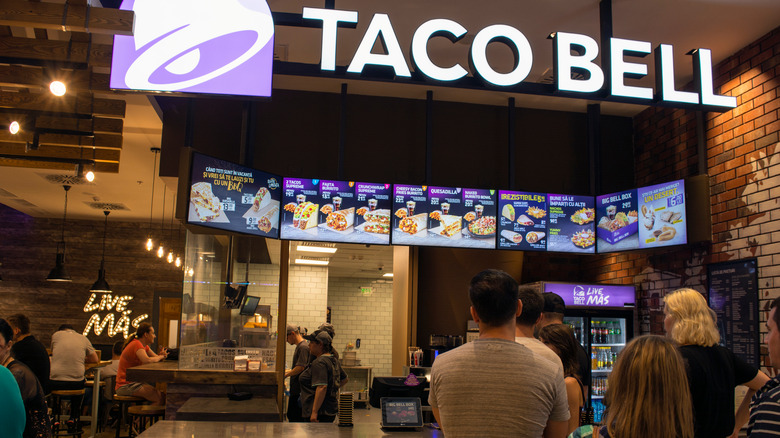 people waiting in line at a Taco Bell restaurant