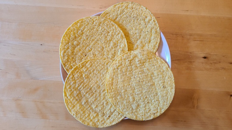 four tostada shells on a plate