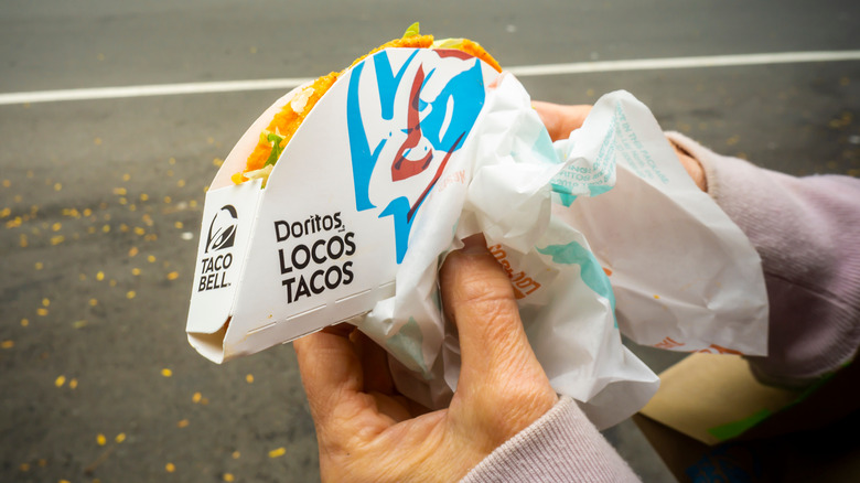 hands holding Taco Bell taco