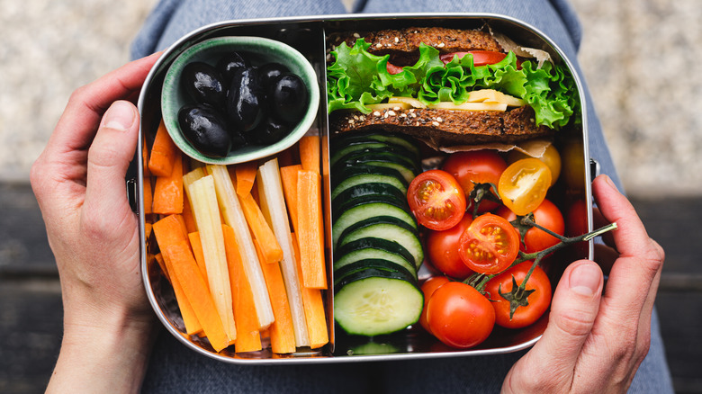 Bento box lunch with sandwich and carrots