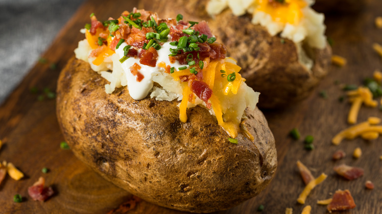 loaded baked potato with chives, bacon, and cheese