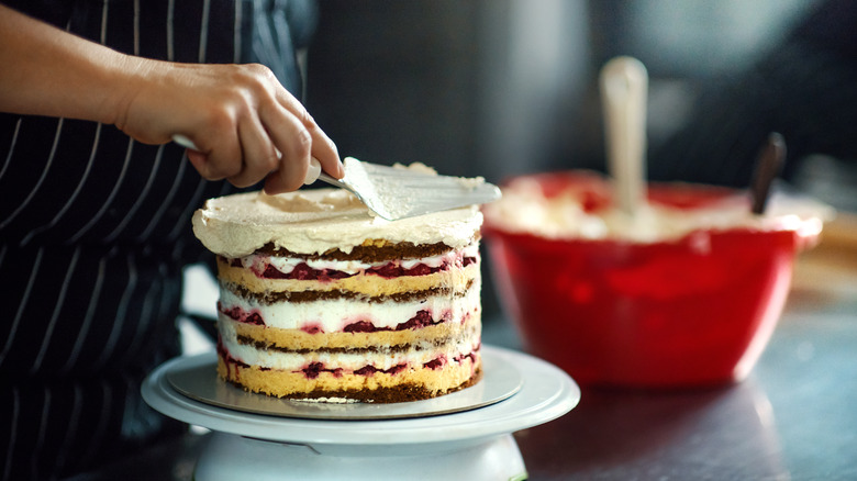 Person frosting a cake