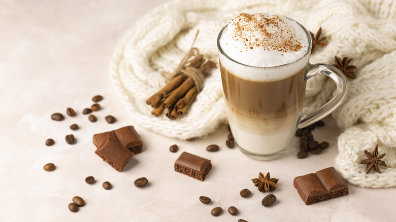 mug of coffee next to chocolate pieces