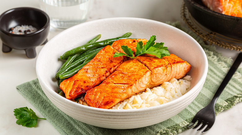 bowl of salmon and green beans over rice