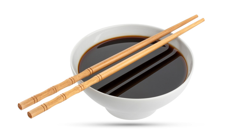 Soy sauce in bowl with chopsticks