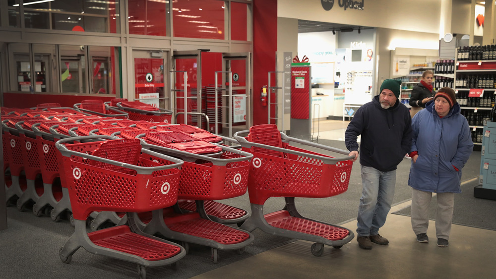 Target customers grabbing a grocery cart