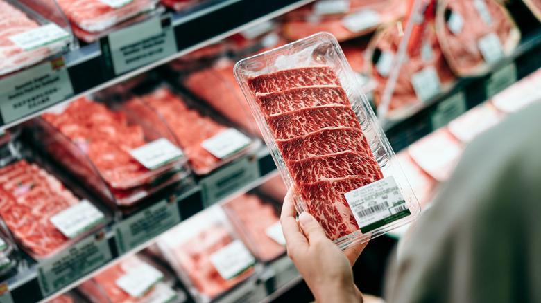 person picking out steak