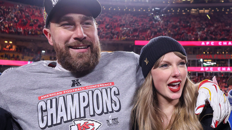 Taylor Swift and Travis Kelce embracing at football game