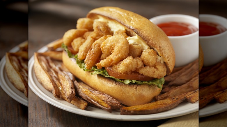 Shrimp po' boy sandwich with fries